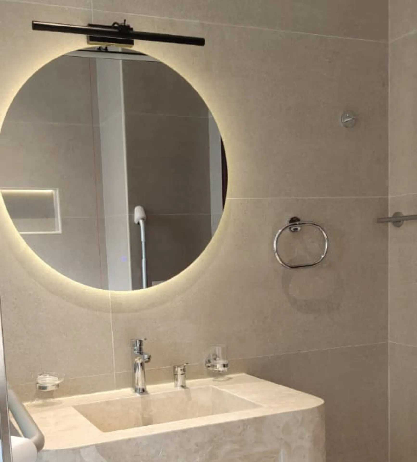 Bathroom wall switch positioned at an accessible reach height