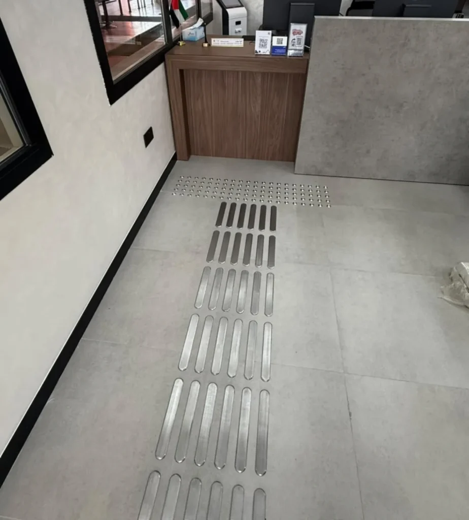 Yellow tactile paving tiles installed by Flex Access at a vehicle testing centre in Dubai