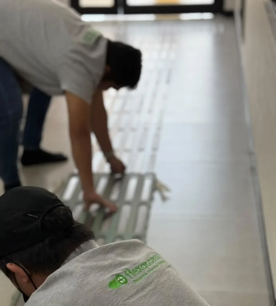 Flex Access team installing tactile paving at AG Cars vehicle testing centre
